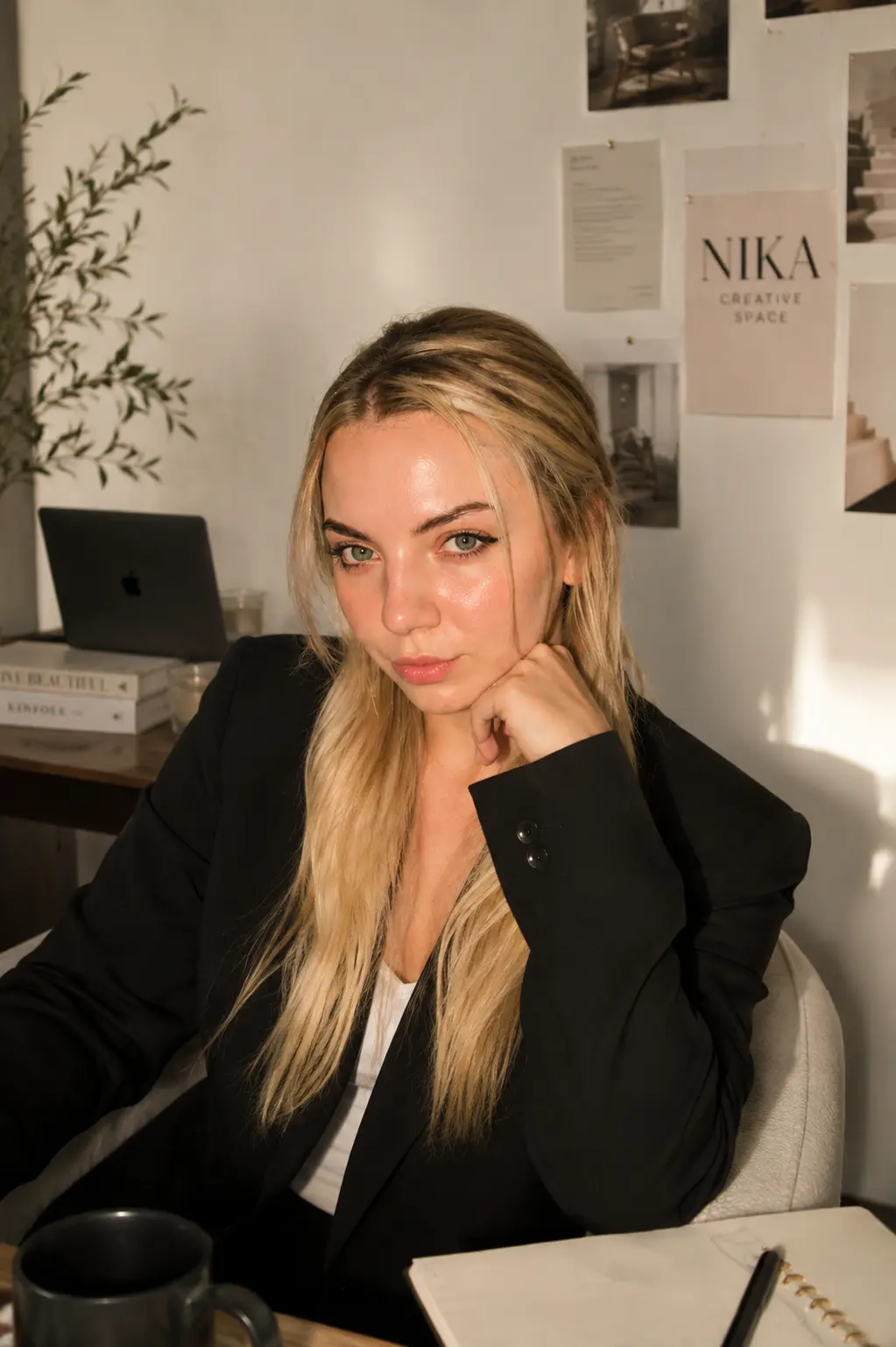 Veronika at her desk beside a notebook and coffee